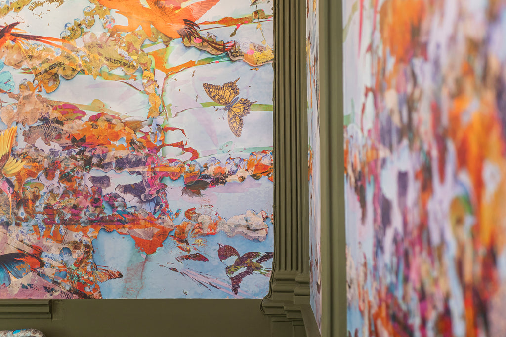 Close-up detail of ‘Ariel Dawn Chorus’  featuring butterflies and birds of paradise, styled next to green painted cove joints. 