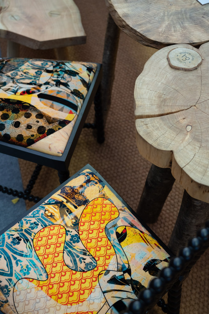 Black dining chairs seats upholstered in Walladawn velvet with yellow, blue and red details 