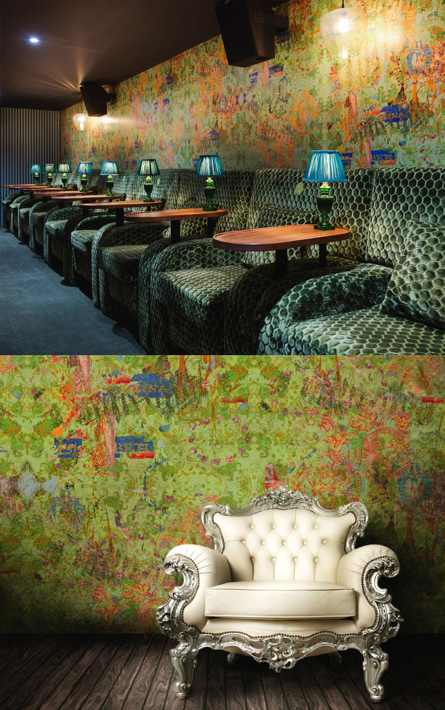 Decorative interior with patterned walls and green upholstered chairs, featuring a close-up of a white ornate chair.