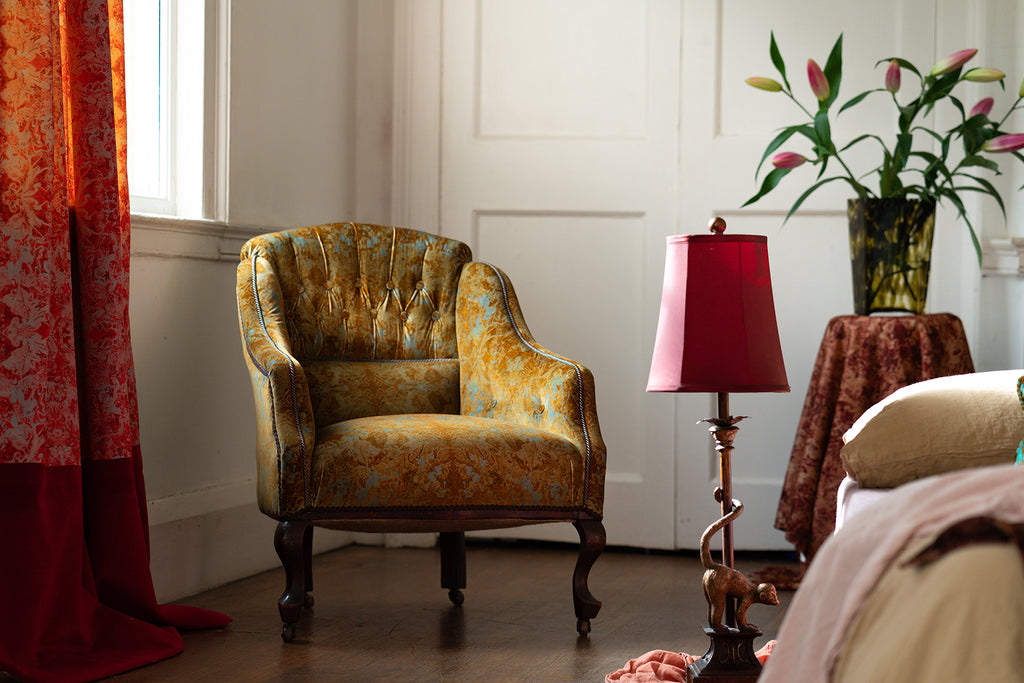 Garbo golden blue vintage style armchair in Blackpop fabric. 