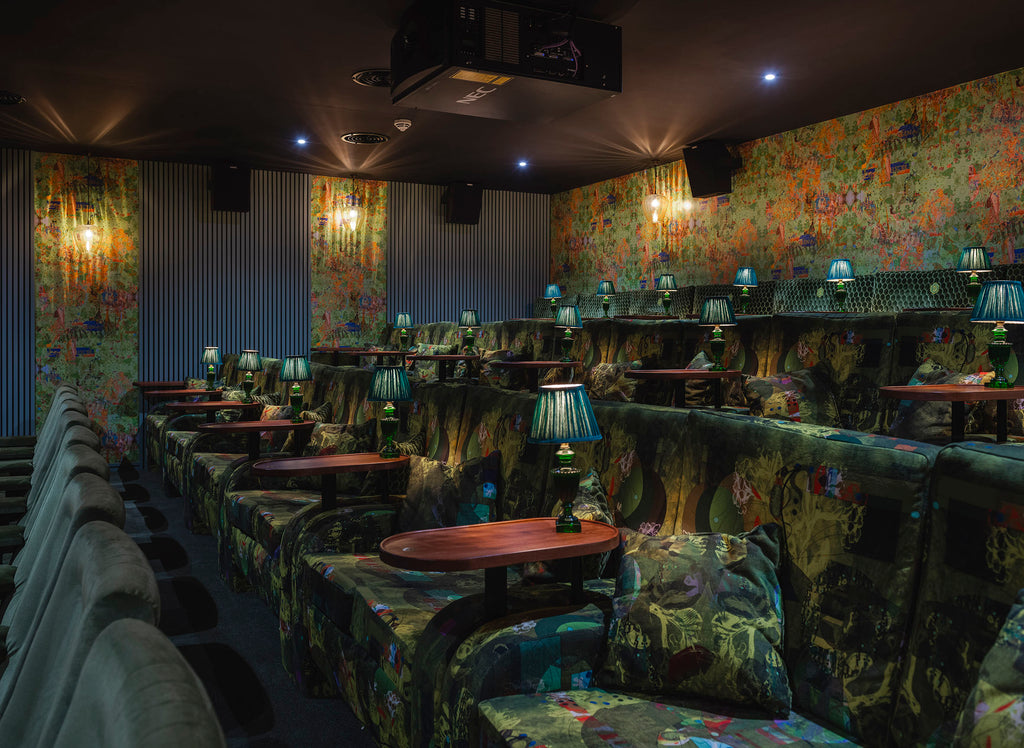 Cinema room with Elektra sustainable fabric seating - bold abstract velvet in green and yellow for vibrant commercial interiors 
