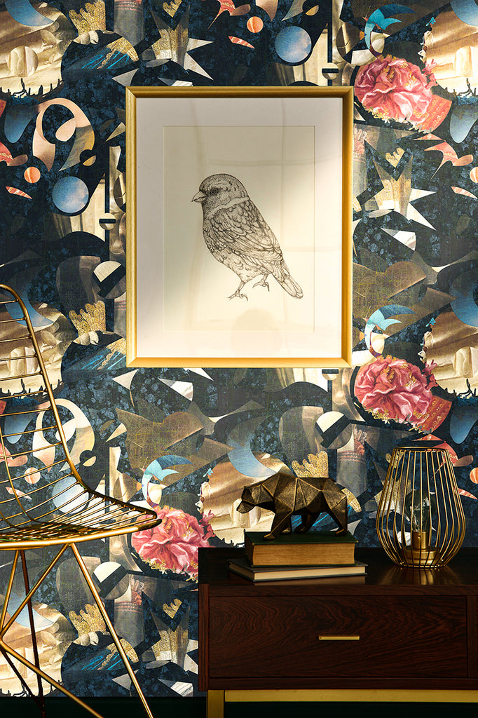 Labyrinth wallpaper in a living room with framed art and a gold chair in front. 