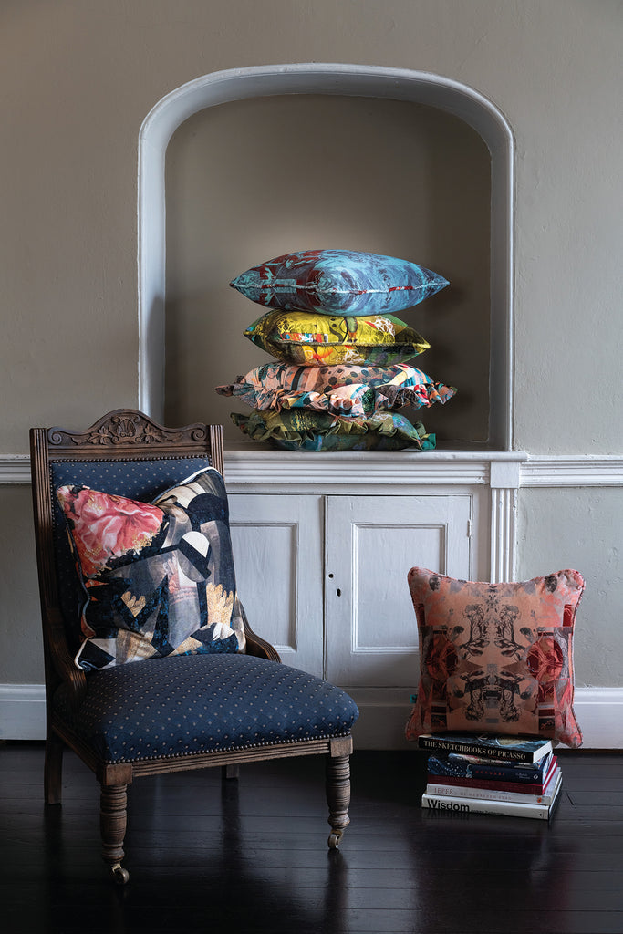 Blackpops velvet cushion in a room, cushions include pink, blue and green.