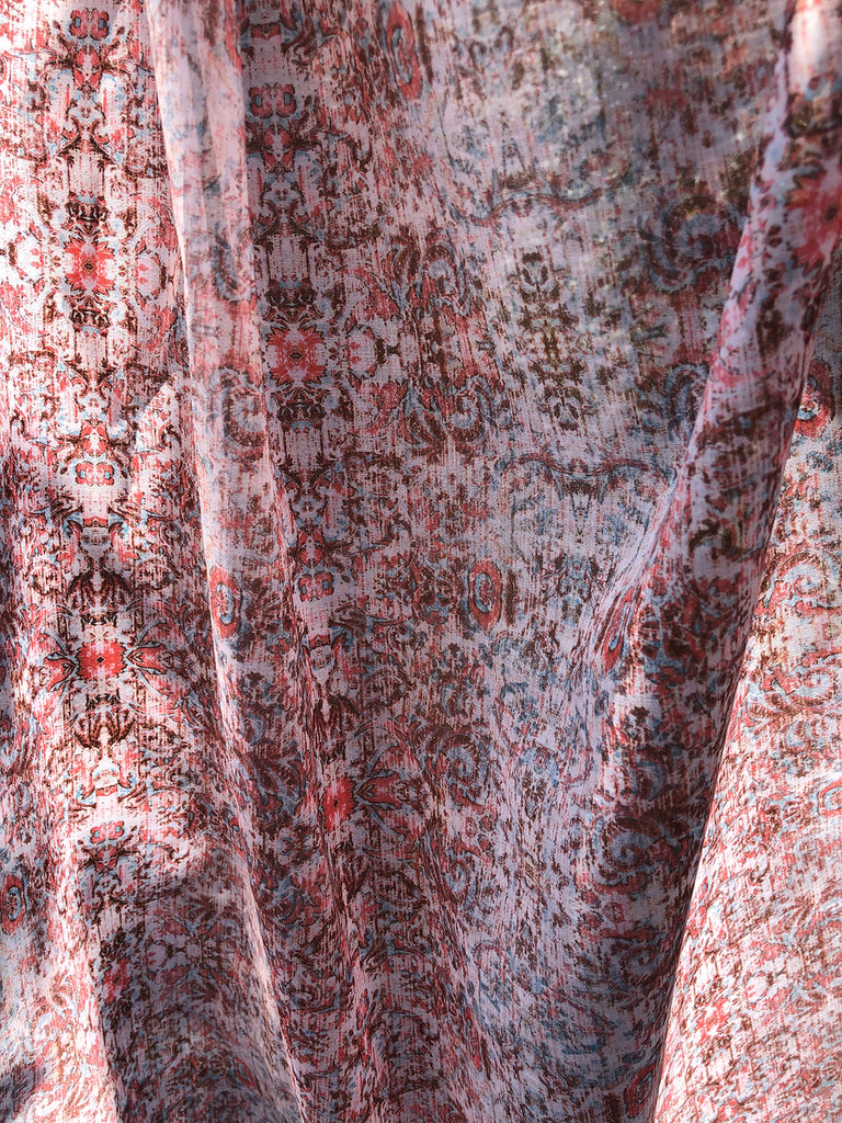 Layered voile drapes in sheer cotton with damask with in pinks an reds and blue 