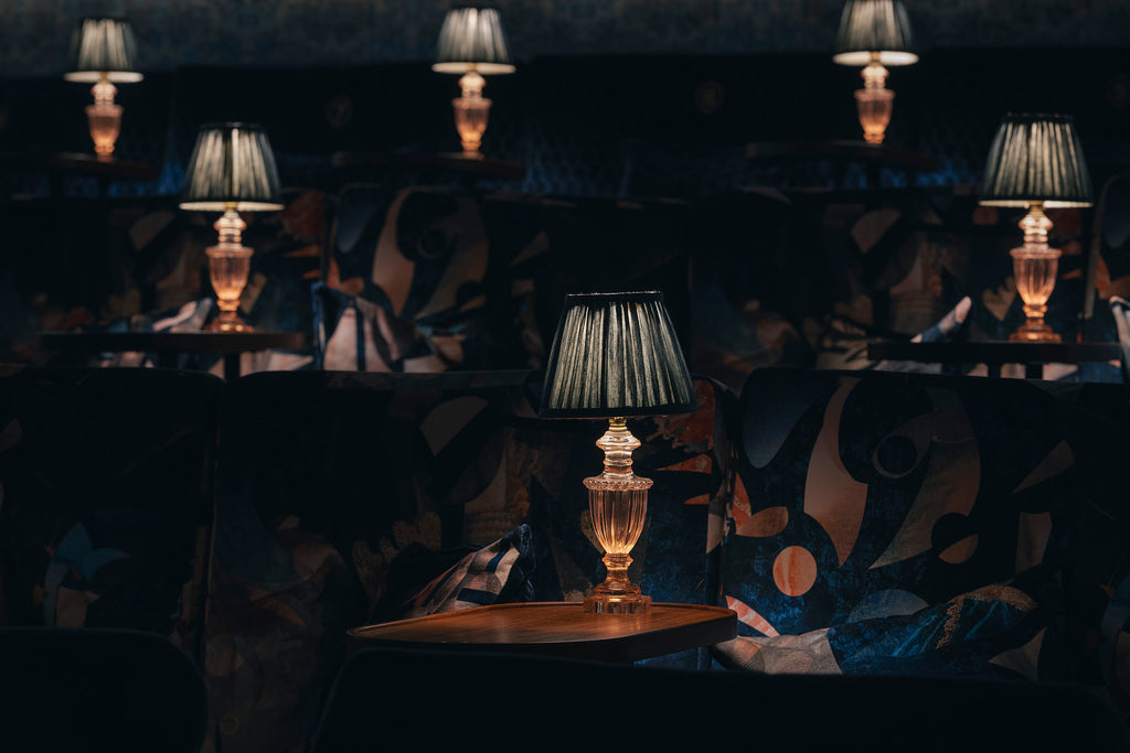 Sustainable Labyrinth velvet upholstered on cinema chairs in a moody cinema room. 