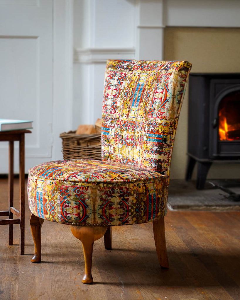 Tub chair upholstered in Fresco luxury velvet fabric with bold architectural inspired pattern 