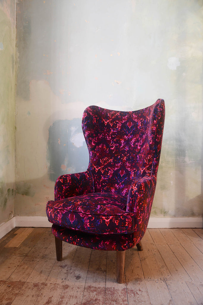Wingback chair in Moulin fabric - rich velvet with ornate damask design in red, fuchsia and plum 