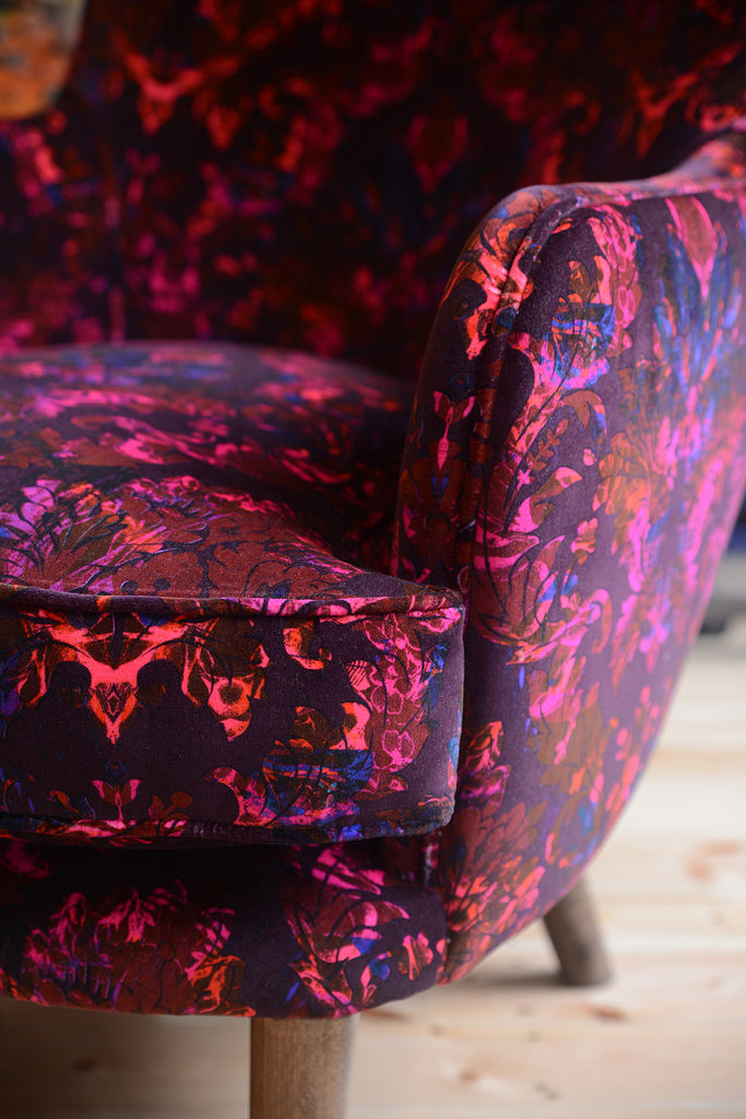 Close up detail chair arm - velvet digitally printed fabric in dark plum, magenta and bright pink 