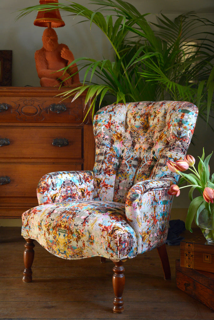 Armchair upholstered in Neo13 luxury velvet with delicate patterns in pastel colours of pinks, blues, greys and greens printed onto velvet 