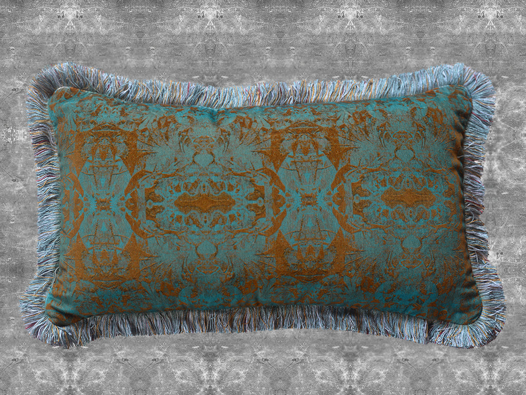 Oscar velvet cushions with intricate pattern and fringes on a textured grey background.