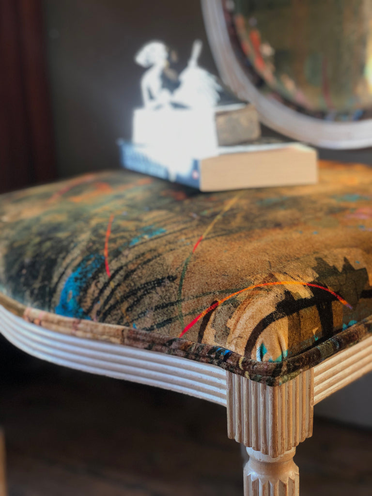 French chair in Kado velvet close up with two books on top. 