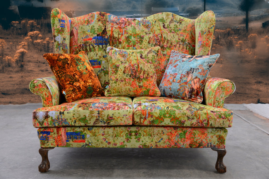 Statement sofa in Elizabeth velvet - green and red printed fabric with historic pattern in modern interior 