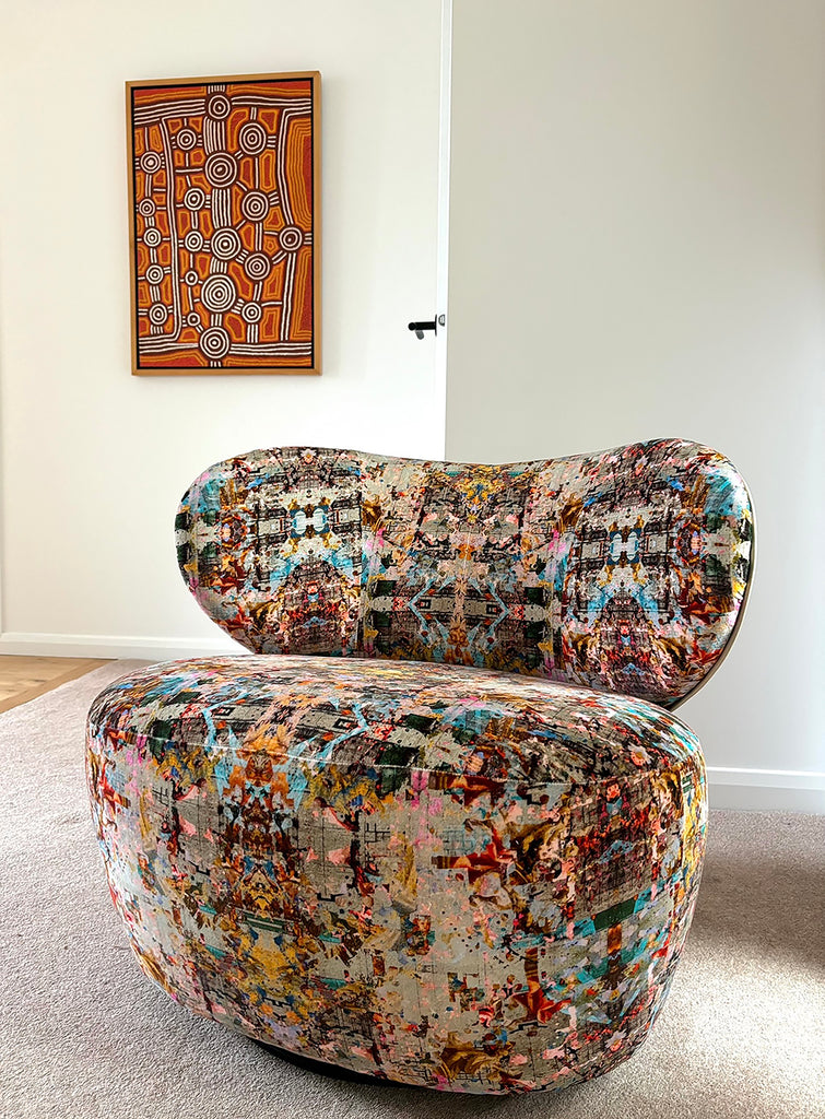 Modern curved seat upholstered in Neo13 luxury velvet showcasing dramatic red, pink and blue with detailed abstract pattern 