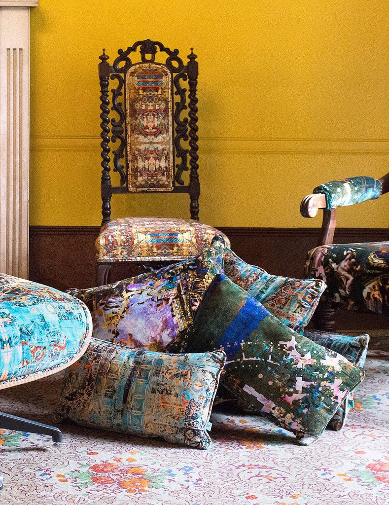 a selection of beautiful velvet scatter cushions and a yellow antique chair