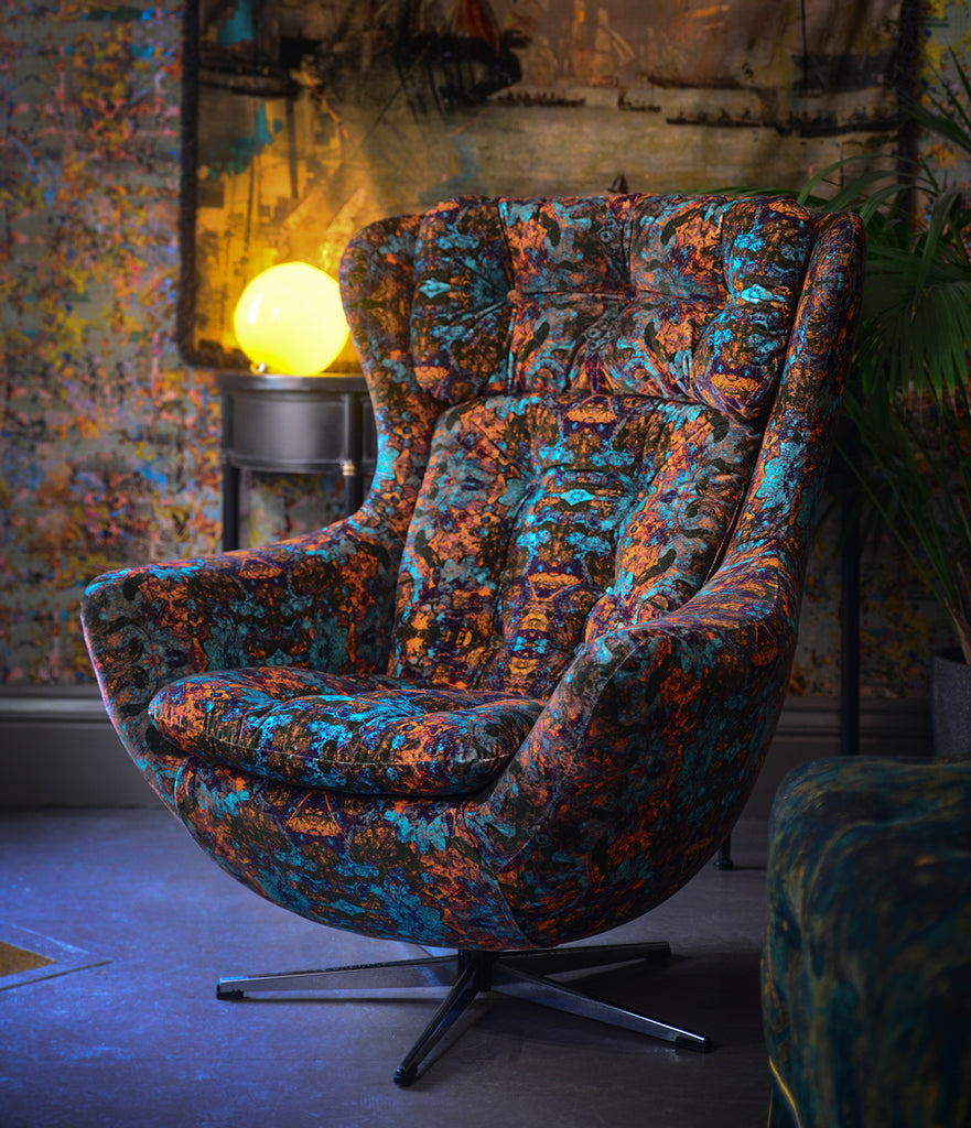Armchair upholstered in Rosetta velvet fabric with bold abstract jewel-toned design 
