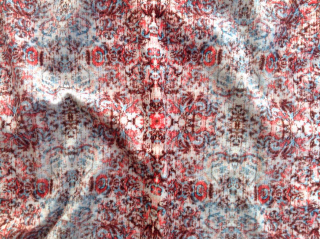 Close-up of Chapelle Sunset velvet - worn damask pattern in muted red, pink and grey with vintage- inspired feel 