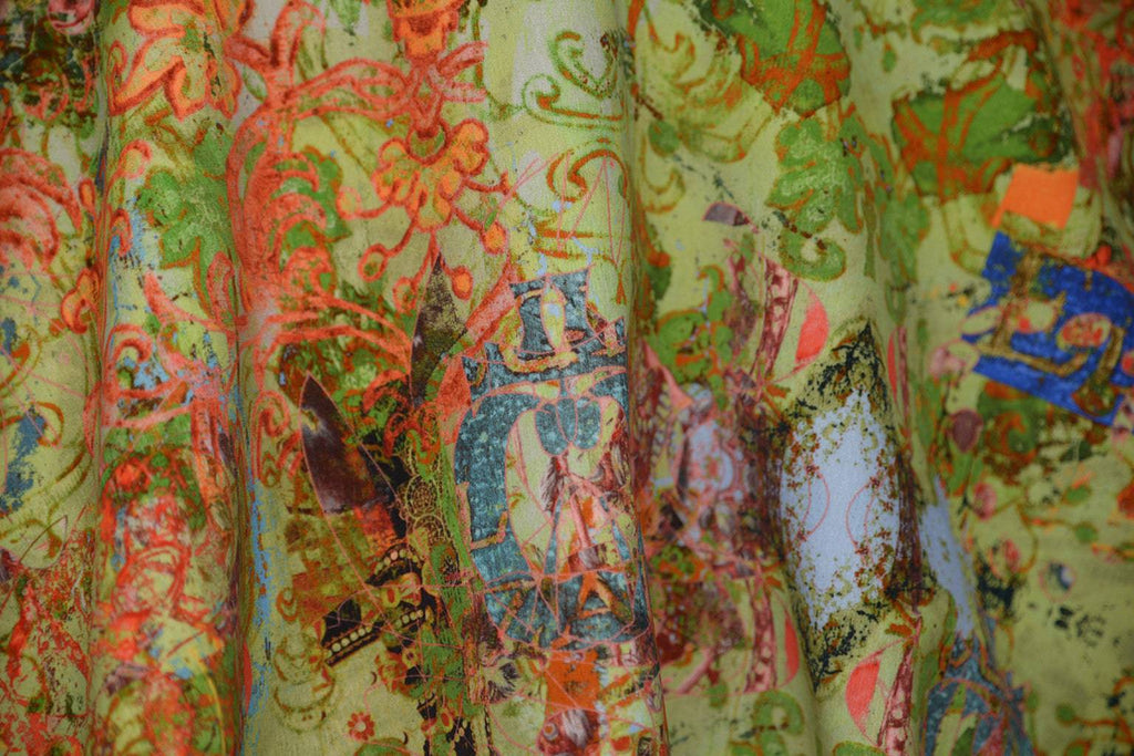 Close-up of Elizabeth fabric - richly textured velvet with green base and painterly red and blue accents 